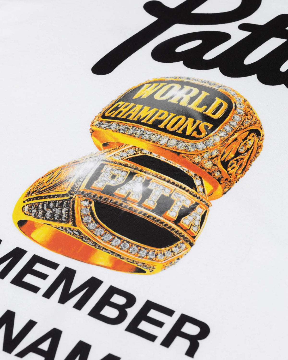 Close-up of the gold championship rings graphic print on the white Patta Championship T-Shirt.