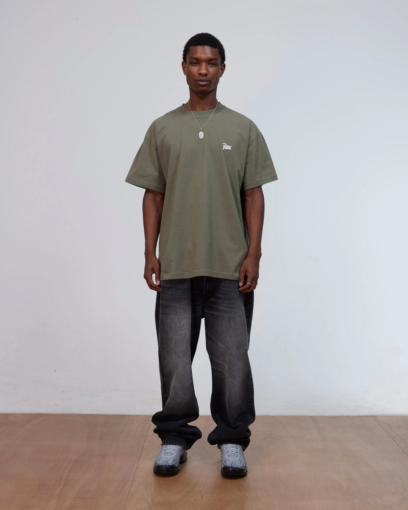 Front view of a model wearing the Patta Championship T-Shirt in dusty olive cotton jersey.