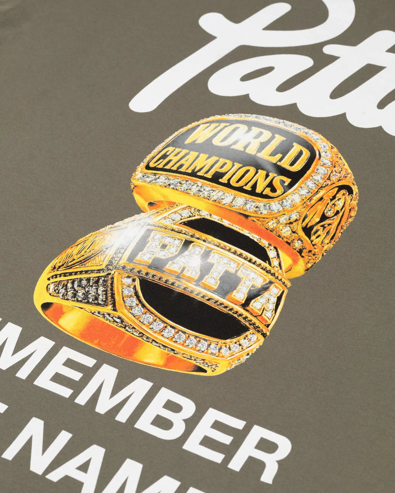 Close-up of the championship ring graphic on the dusty olive Patta Championship T-shirt.