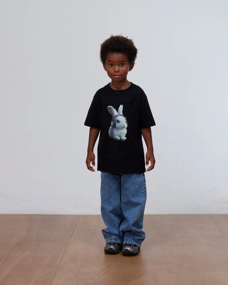 Kid model wearing the black Patta Kids Bunny T-Shirt featuring a bunny graphic.