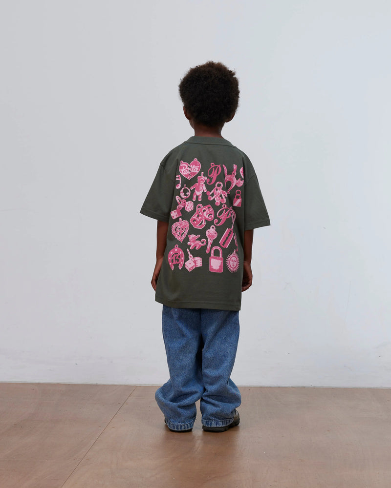Back view of a kid wearing the green Patta Kids Charm T-Shirt with pink charms print.