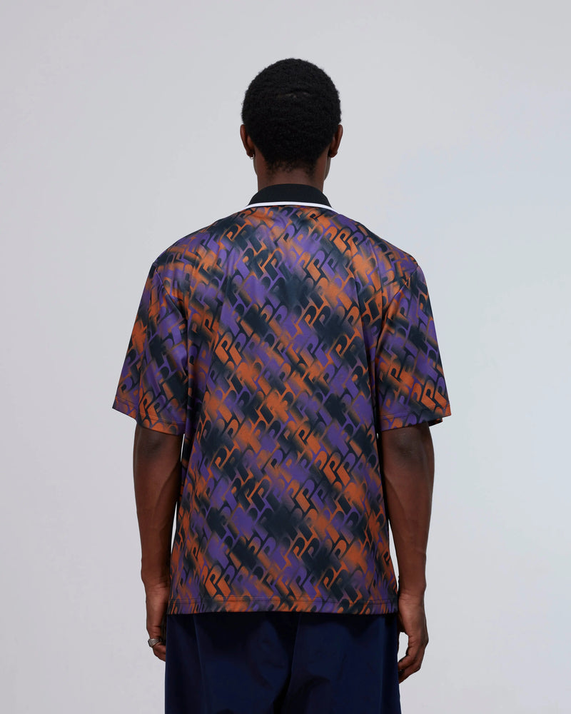 Back view of a model wearing the Patta All Over P Football Jersey in Pansy purple and orange.