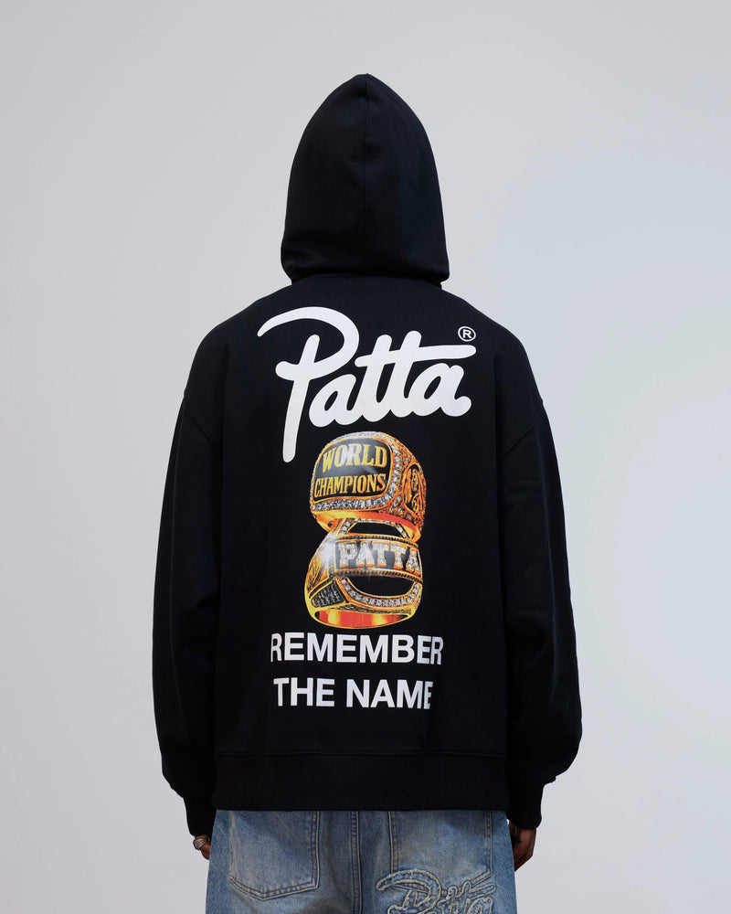 Back view of the Patta Kids Championship Hooded Sweater in black with rings graphic and logo print.