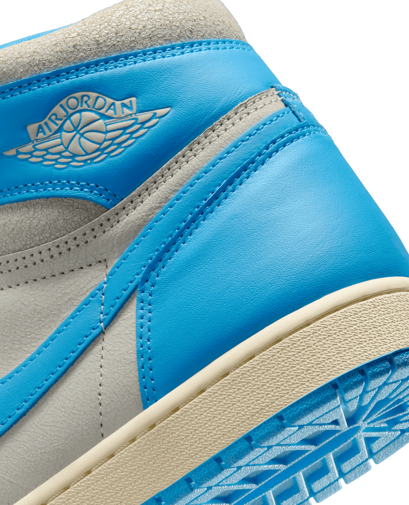Close-up of the Air Jordan 1 Retro High UNC Reimagined collar in powder blue leather with the Wings logo.