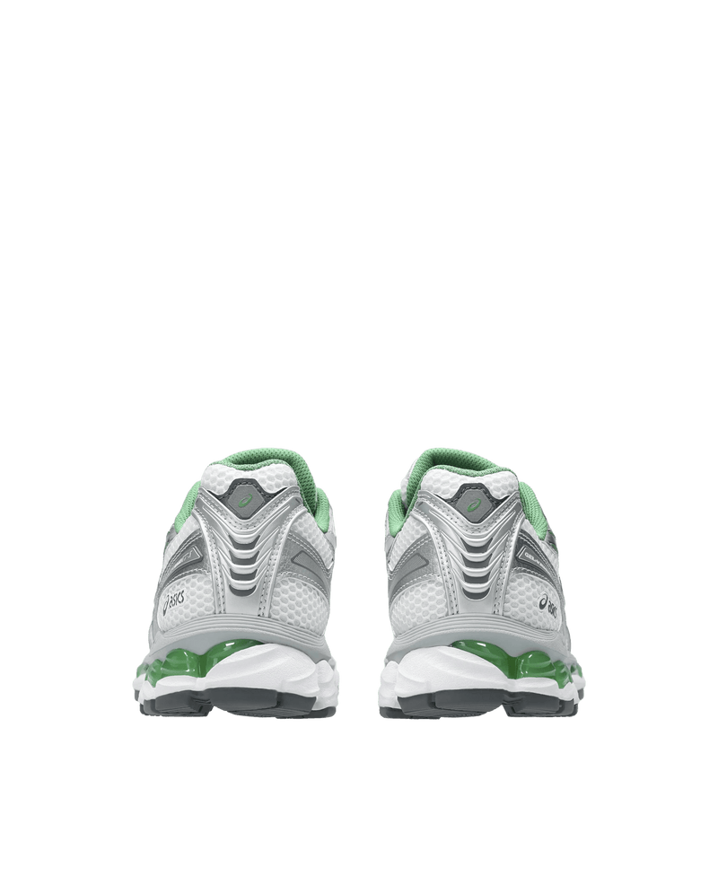 Rear view of ASICS Gel-Kayano 12.1 sneakers in white and pure silver with green Gel cushioning.