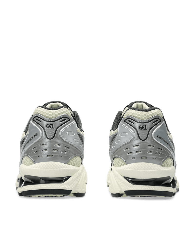 Rear view of ASICS Gel-Kayano 14 sneakers in Oyster White and Steeple Grey with metallic silver overlays.