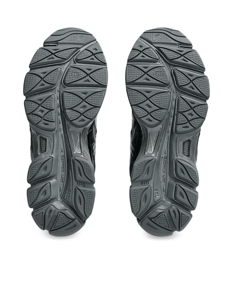 Bottom view of black Asics Gel-NYC sneakers displaying the rubber outsole tread pattern.