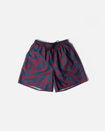 ByParra Splashed Swim Shorts in burgundy with an all-over wavy blue print laid flat.