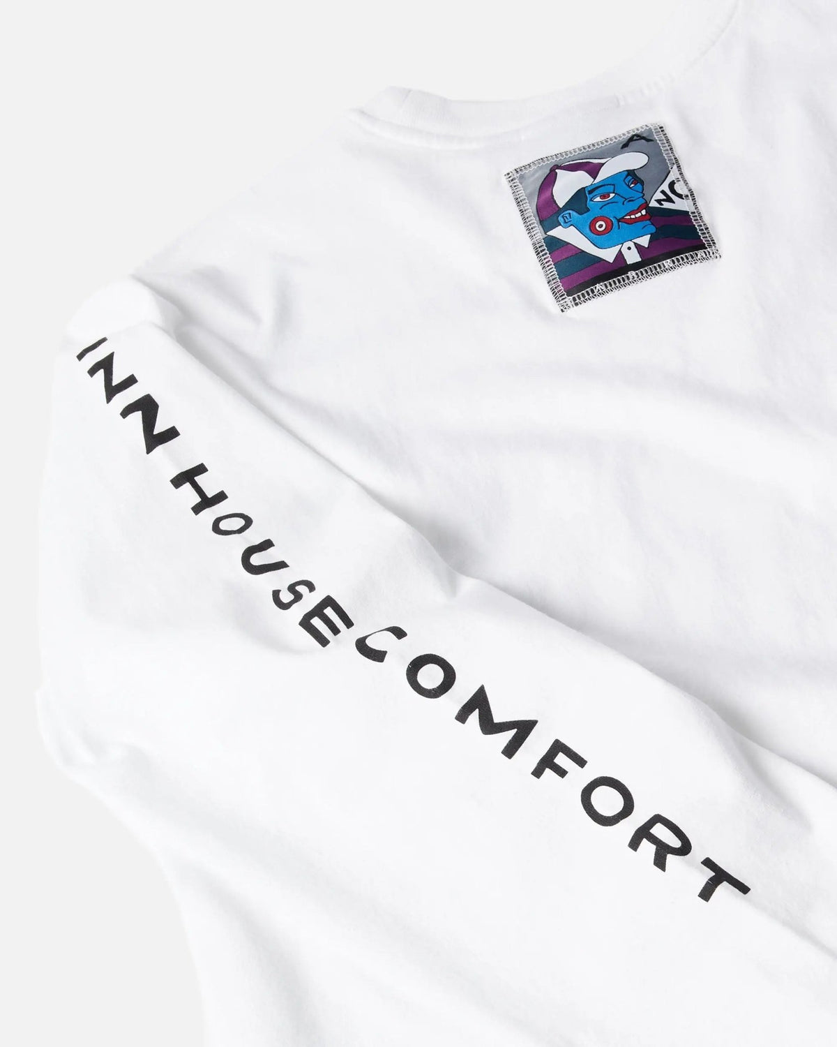 Close-up of the white ByParra Your Face long sleeve T-shirt with sleeve print and graphic patch.