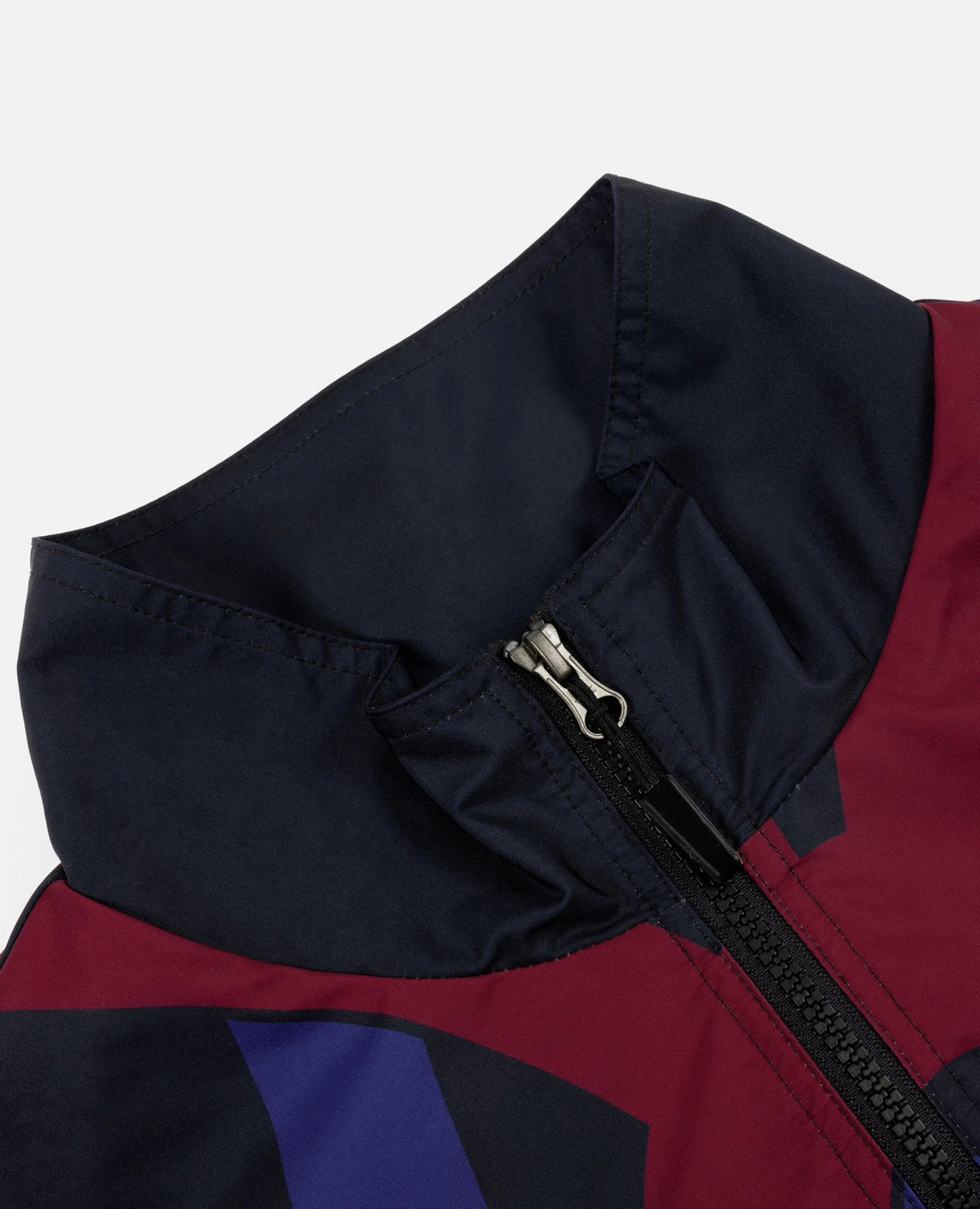 Close-up of the high collar and front zip on the FCB x Patta Culers del Món Track Jacket.