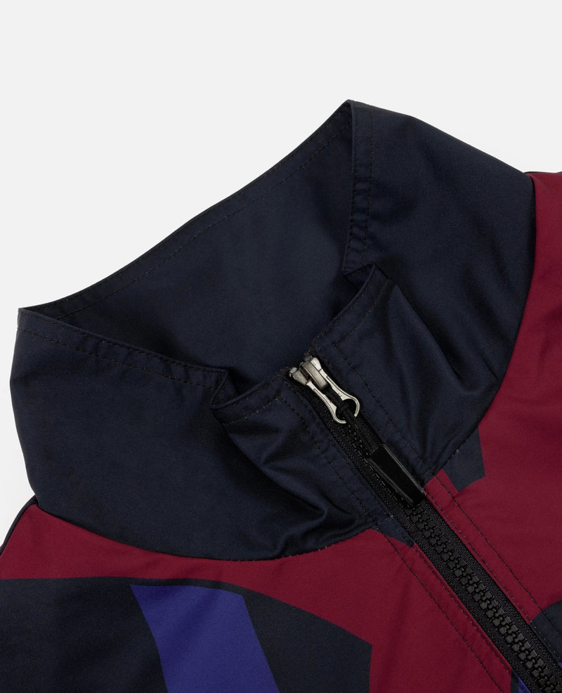Close-up of the high collar and front zip on the FCB x Patta Culers del Món Track Jacket.