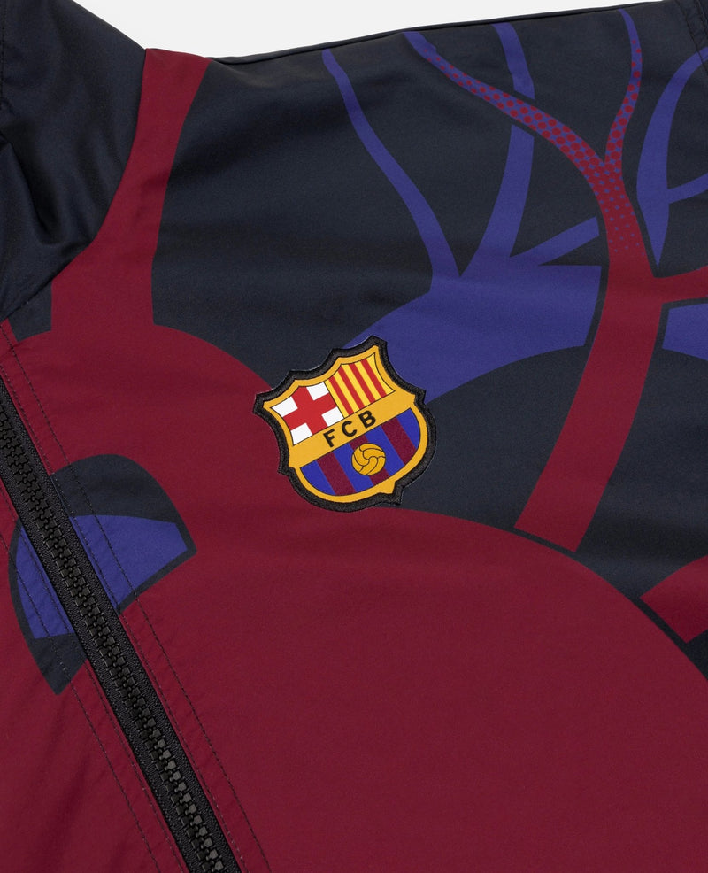 Close-up of the woven FC Barcelona crest on the FCB x Patta Culers del Món Track Jacket.