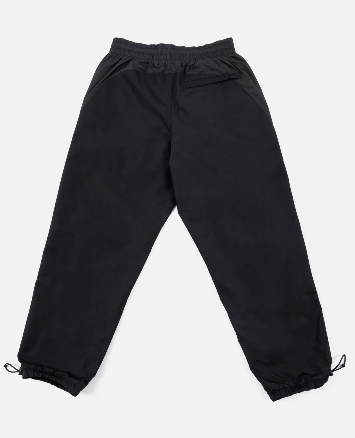 Back view of black FCB x Patta Culers del Món Track Pants with zippered pocket and toggle hems.