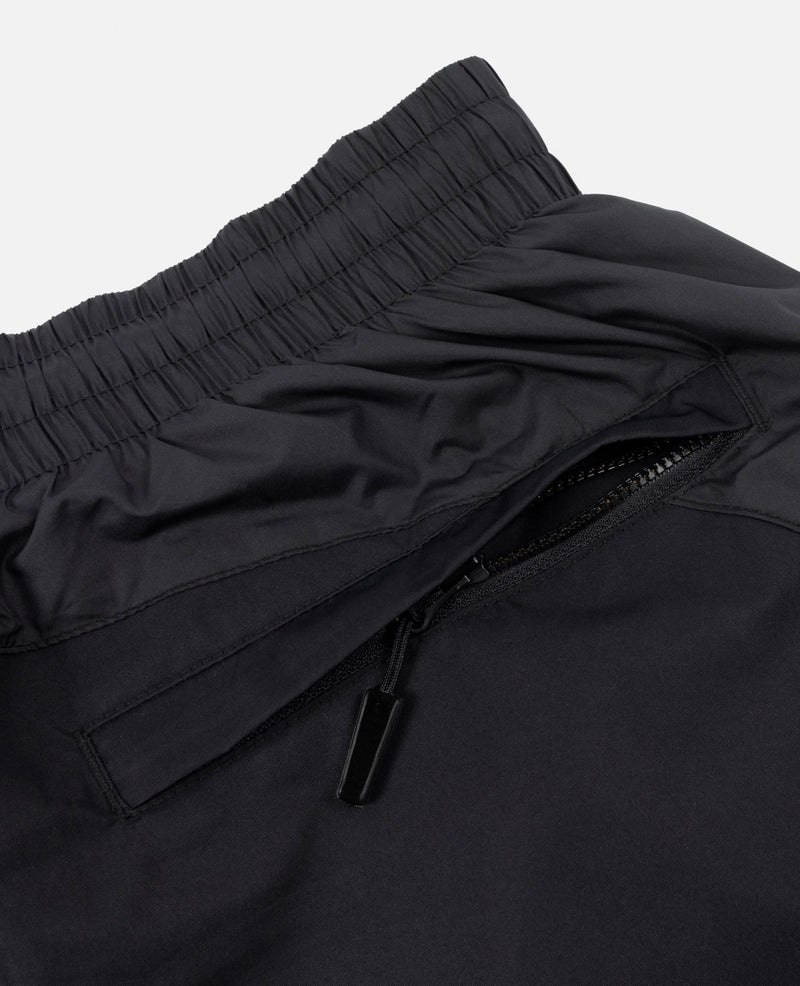Close-up of the zippered pocket and elastic waistband on the FCB x Patta Culers del Món Track Pants in black.