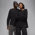 Two models wearing black Jordan x Awake NY waffle-knit long-sleeve thermal shirts.