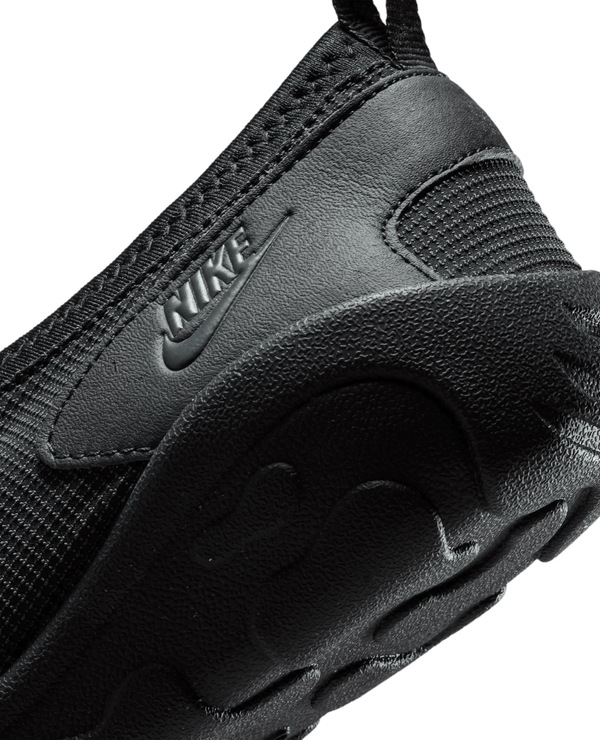 Close-up of the Nike Aqua Turf shoe heel in black, showing textured mesh, leather overlay, and embossed Nike logo.