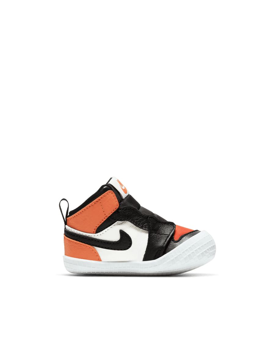 Nike Jordan 1 Crib Bootie infant sneaker in a sail, black, and starfish orange colorway from a side view.