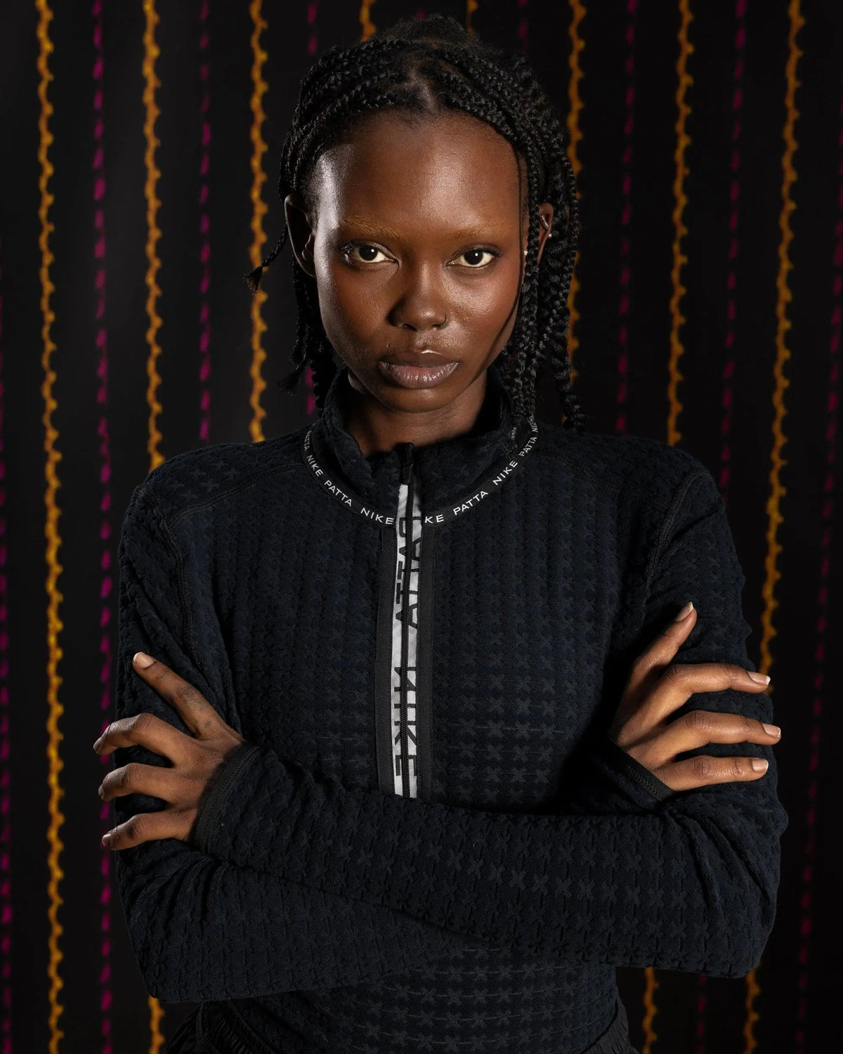 Model wearing the Nike x Patta Running Team black jacquard knit half-zip longsleeve top.