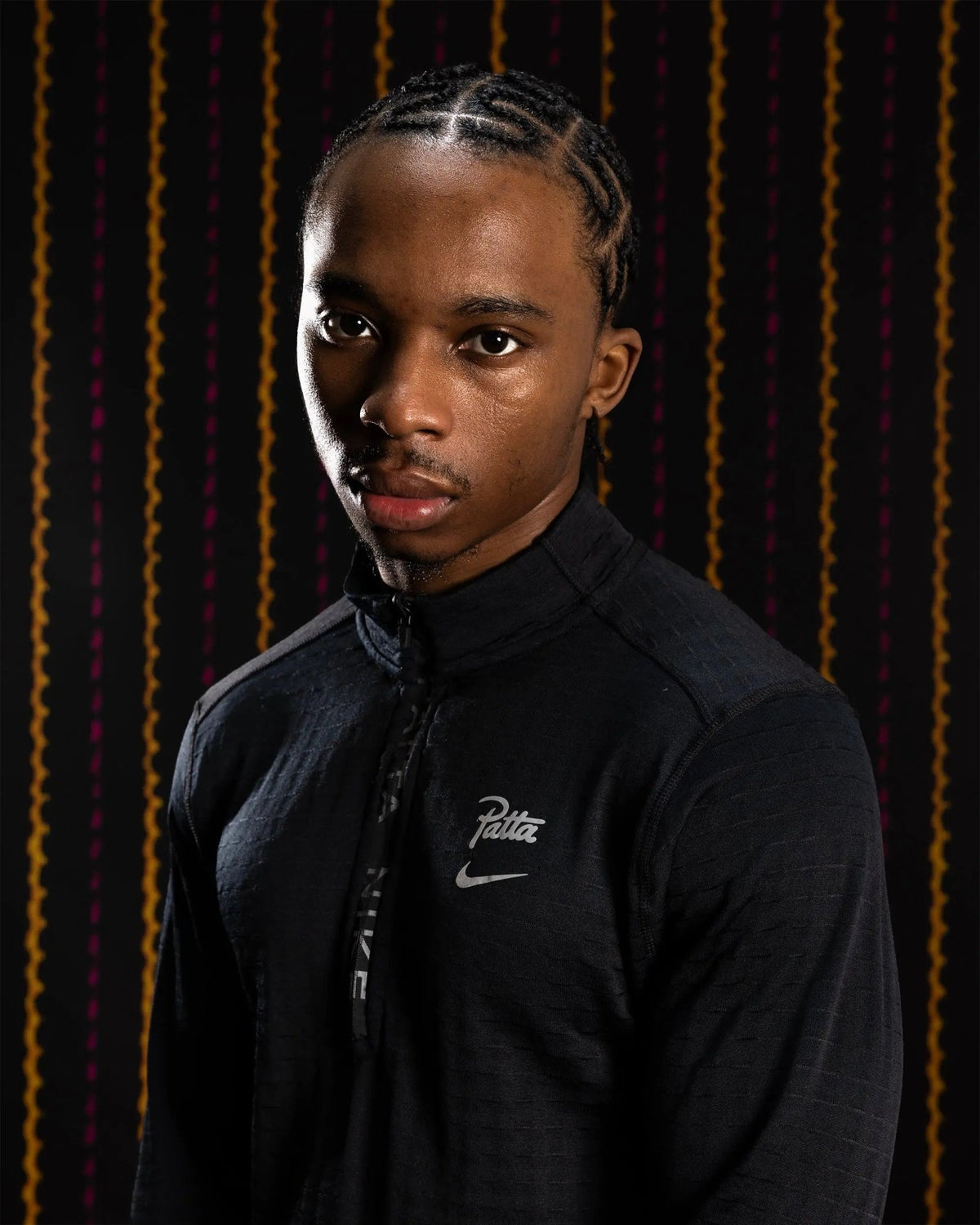 Nike x Patta Running Team black half-zip longsleeve top worn by a model.