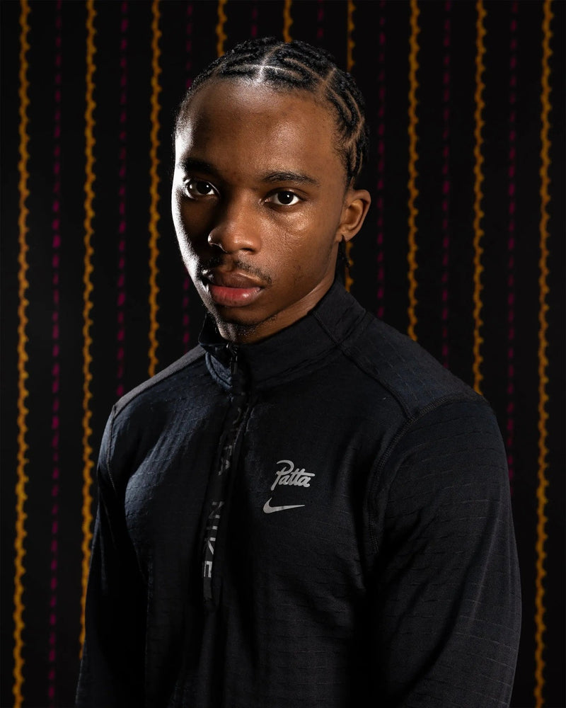 Nike x Patta Running Team black half-zip longsleeve top worn by a model.