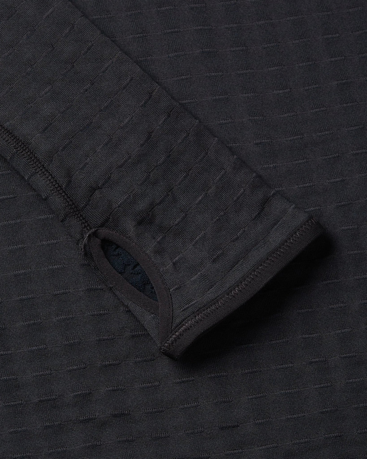 Thumbhole cuff detail on the black Nike x Patta Running Team half-zip longsleeve.