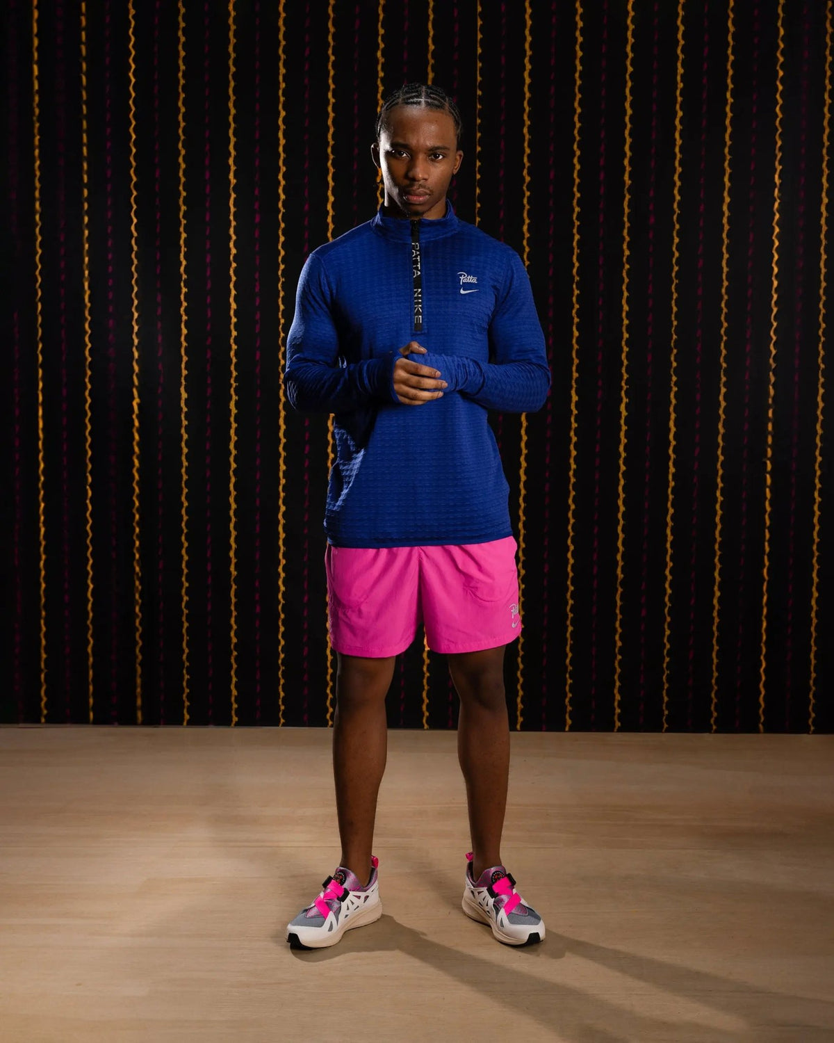 Model wearing the Nike x Patta Running Team half-zip longsleeve in deep royal blue.