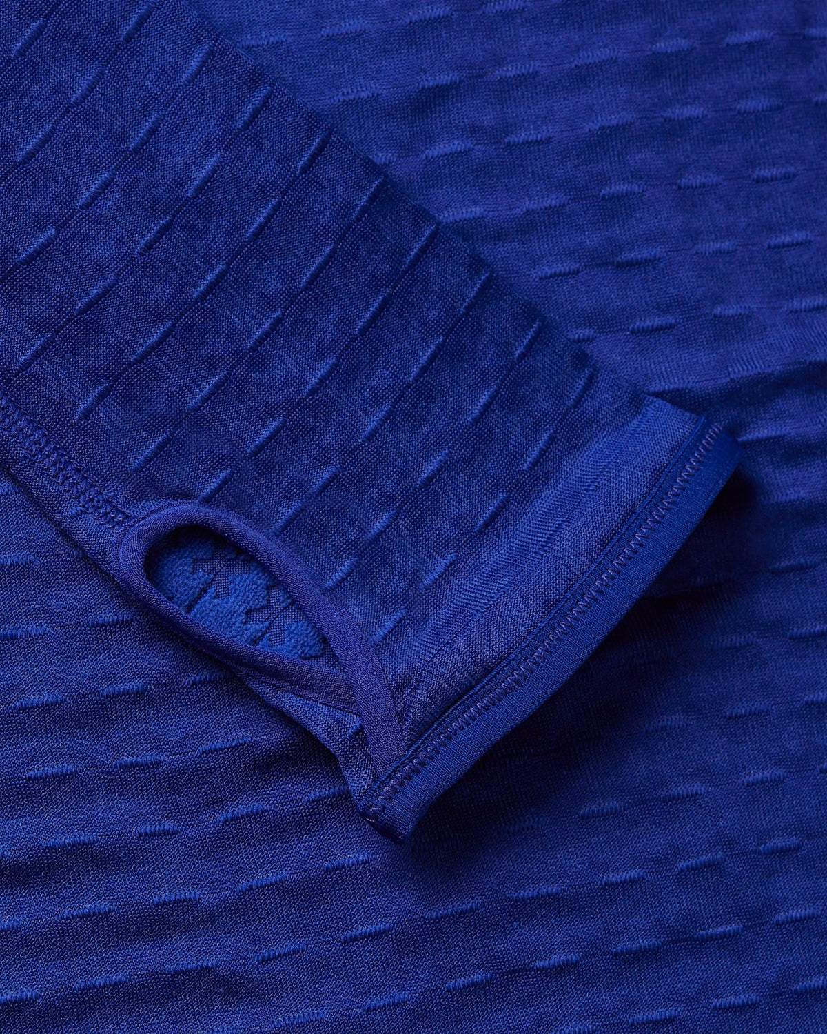 Close-up of the thumbhole cuff on the Nike x Patta Running Team Half-Zip Longsleeve in Deep Royal Blue.