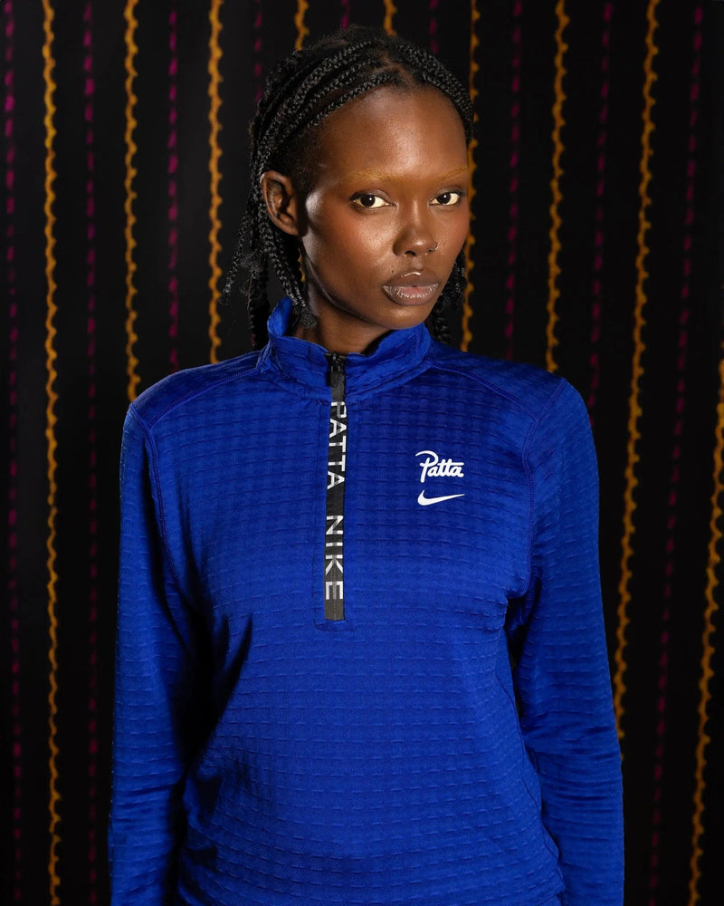 Nike x Patta Running Team half-zip longsleeve in deep royal blue worn by a model.