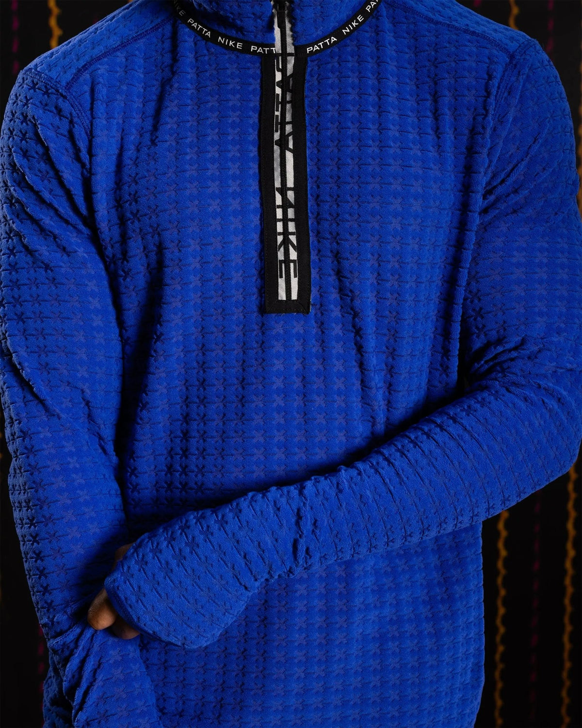 Close-up of the Nike x Patta Running Team half-zip longsleeve in textured deep royal blue jacquard knit.