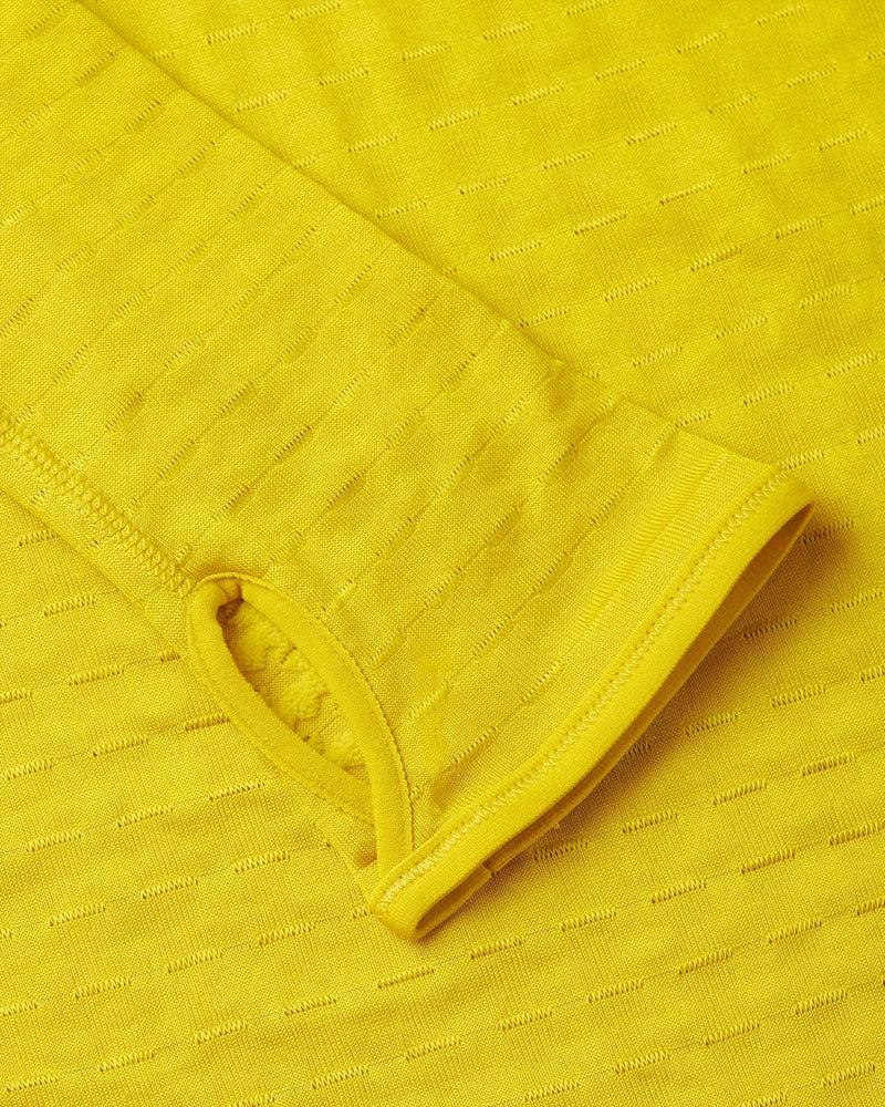 Close-up of the textured yellow sleeve cuff with thumbhole on the Nike x Patta Running Team Half-Zip.