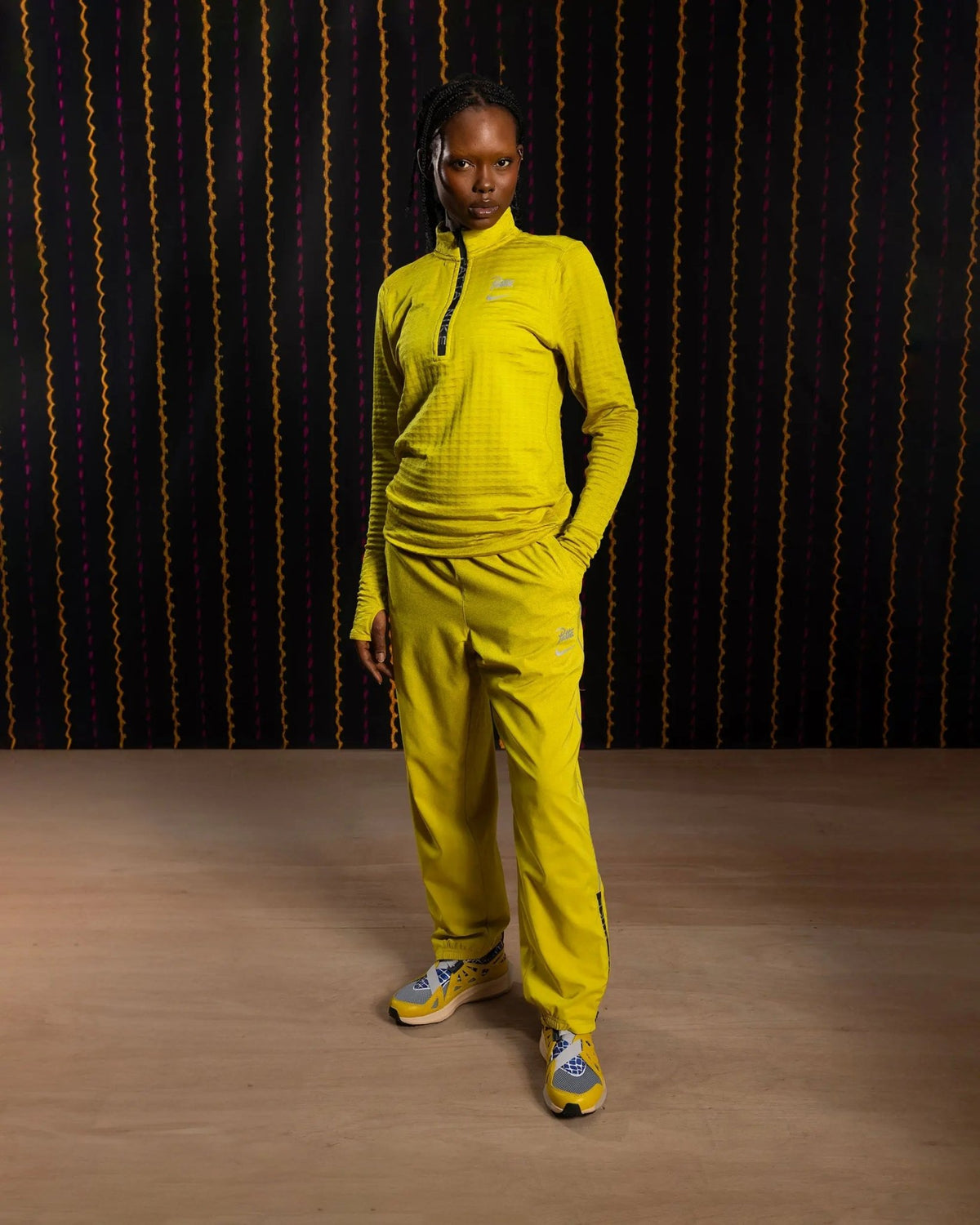 Model wearing the saffron quartz Nike x Patta Running Team half-zip longsleeve.