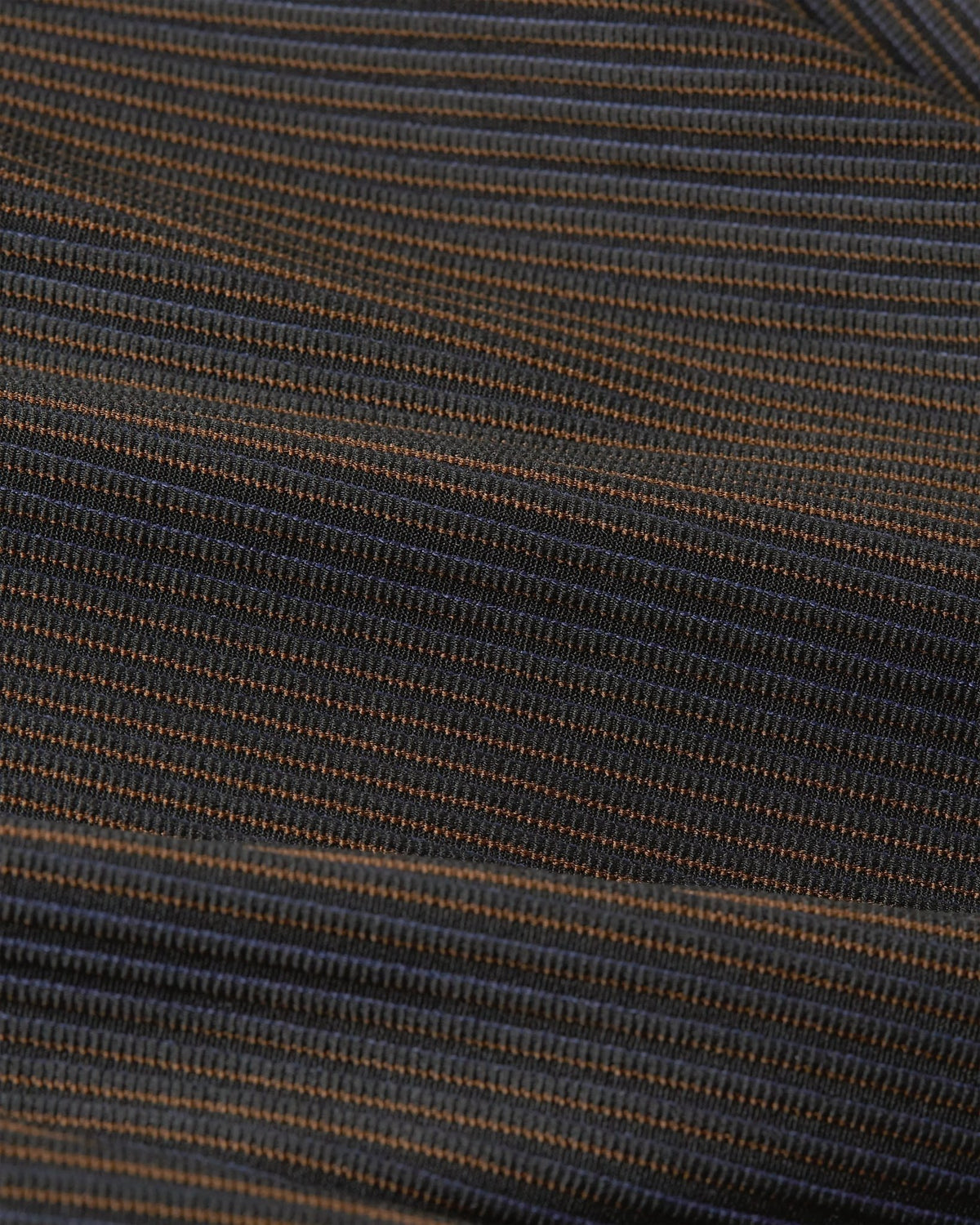 Close-up of ribbed, color-shifting fabric on Nike x Patta Running Team leggings in Black and Deep Royal Blue.
