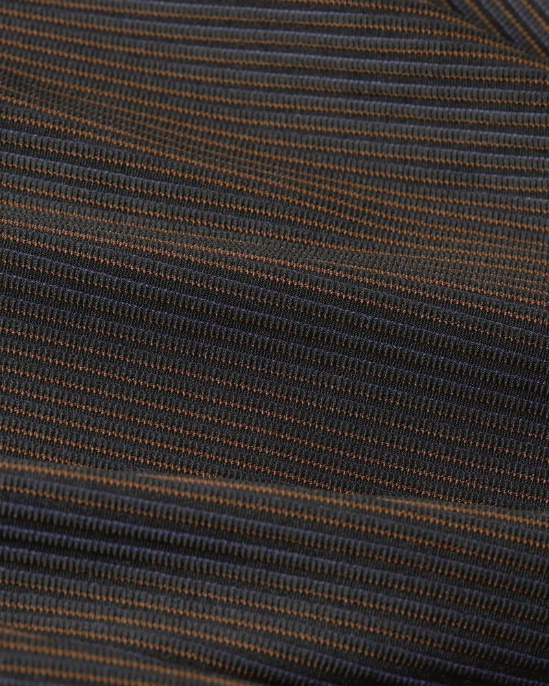 Close-up of ribbed, color-shifting fabric on Nike x Patta Running Team leggings in Black and Deep Royal Blue.