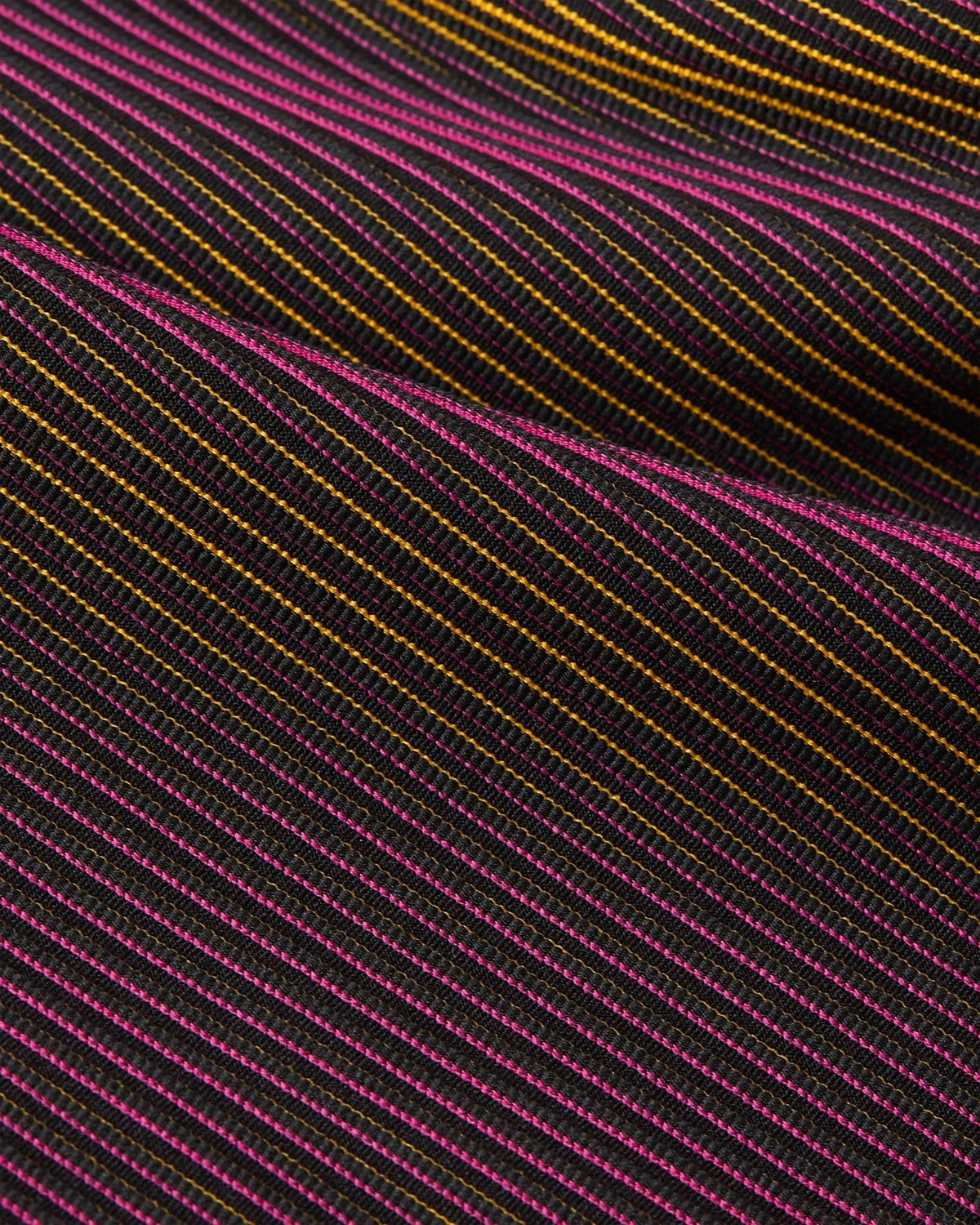 Close-up of the striped Fireberry and Sundial knit texture on the Nike x Patta Running Team leggings.