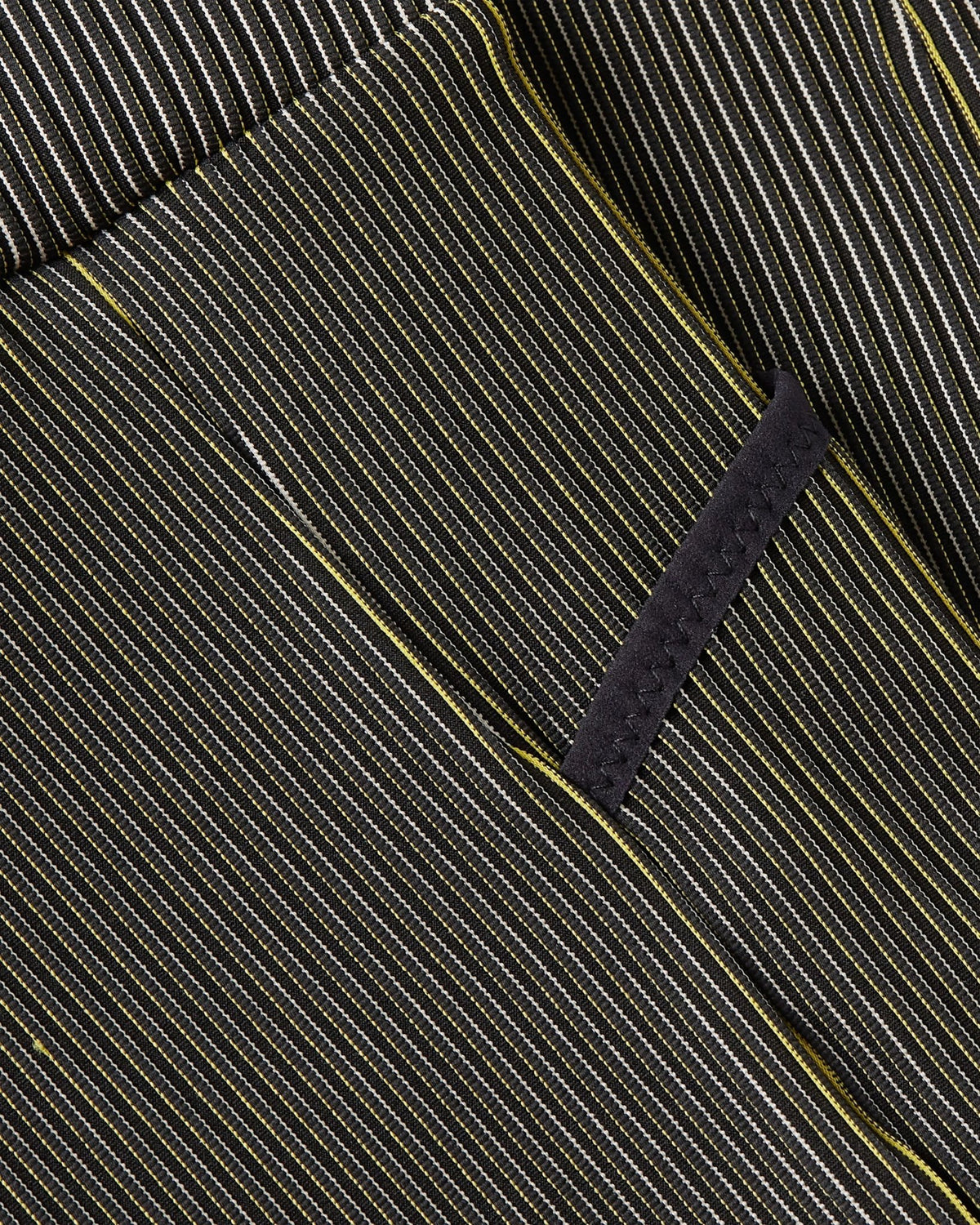 Close-up of Nike x Patta Running Team leggings highlighting the ribbed fabric texture and pocket seam.