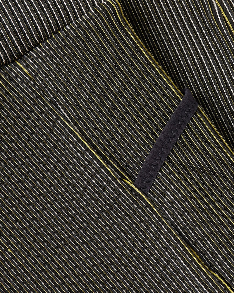 Close-up of Nike x Patta Running Team leggings highlighting the ribbed fabric texture and pocket seam.