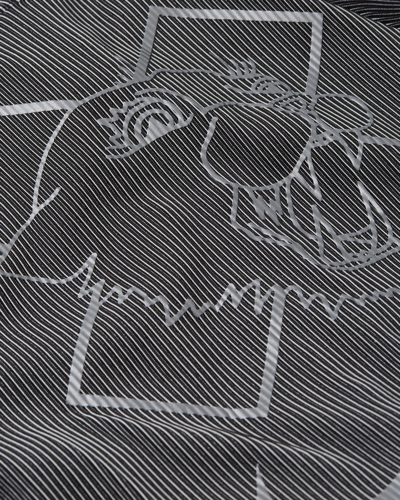 Close-up of reflective graphic print on the Nike x Patta Running Team race suit in black and grey.