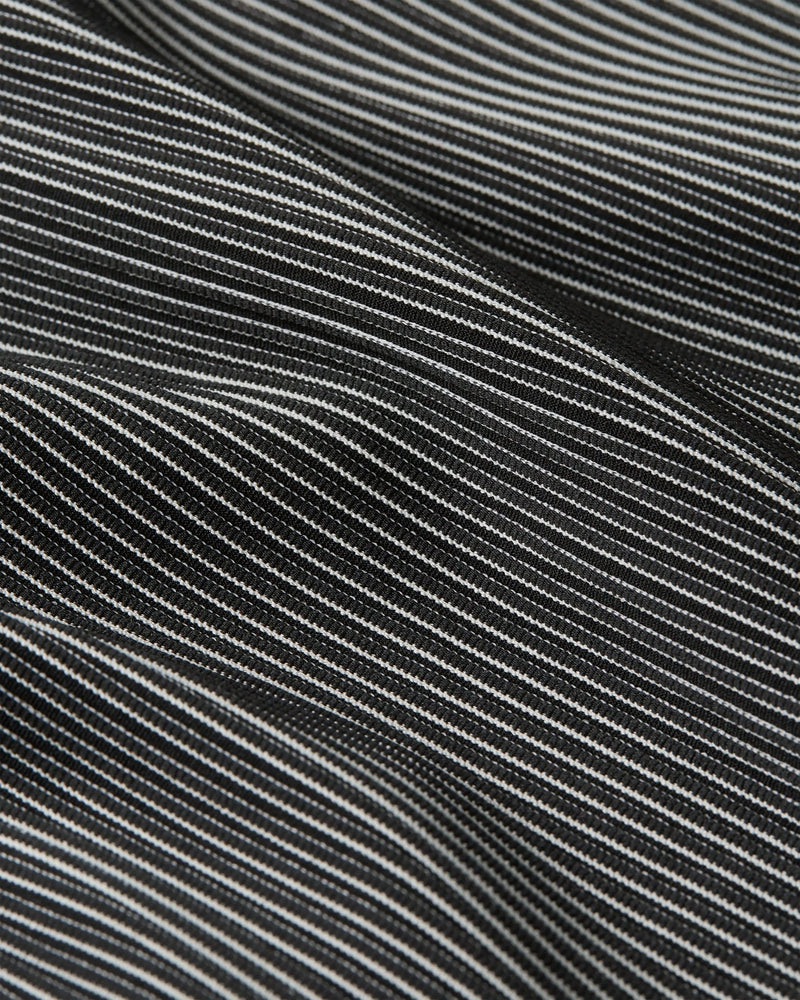 Close-up of the black and grey textured striped fabric of the Nike x Patta Running Team Race Suit.