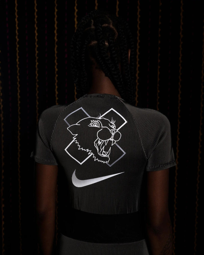 Back view of the Nike x Patta Race Suit in black and grey featuring a reflective panther graphic and Swoosh.