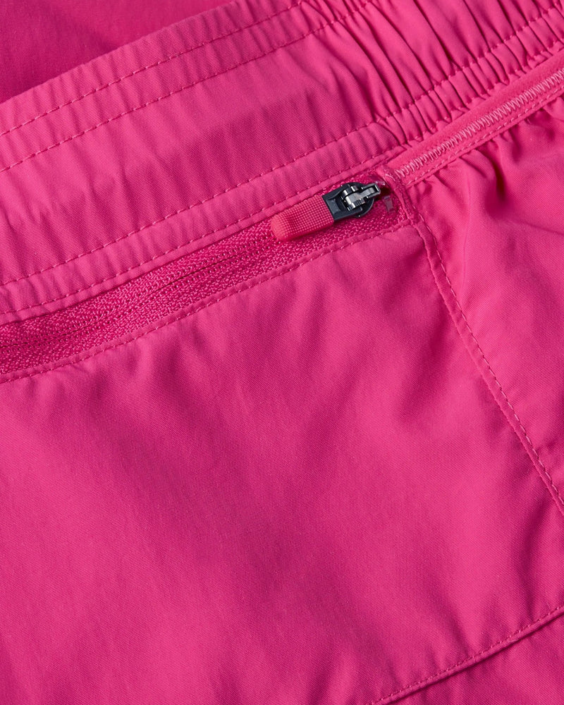 Close-up of the zippered back pocket on the pink Nike x Patta Running Team Shorts.