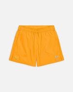 Front view of Nike x Patta Running Team nylon shorts in sundial orange with drawstring waist.