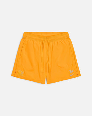 Front view of Nike x Patta Running Team nylon shorts in sundial orange with drawstring waist.
