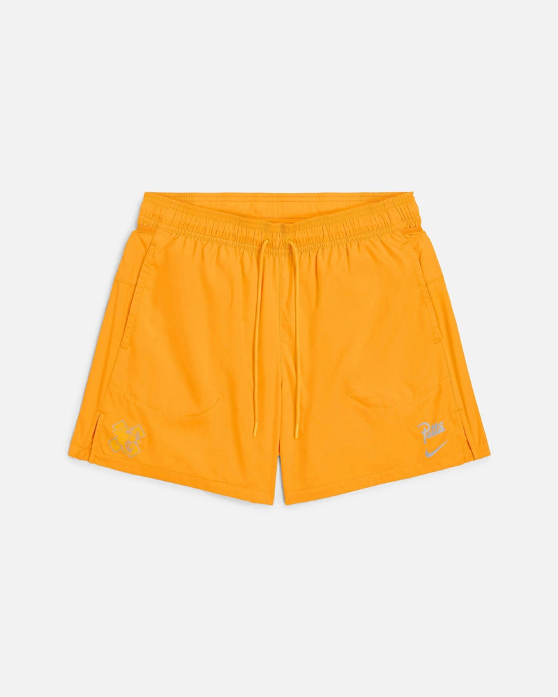 Front view of Nike x Patta Running Team nylon shorts in sundial orange with drawstring waist.