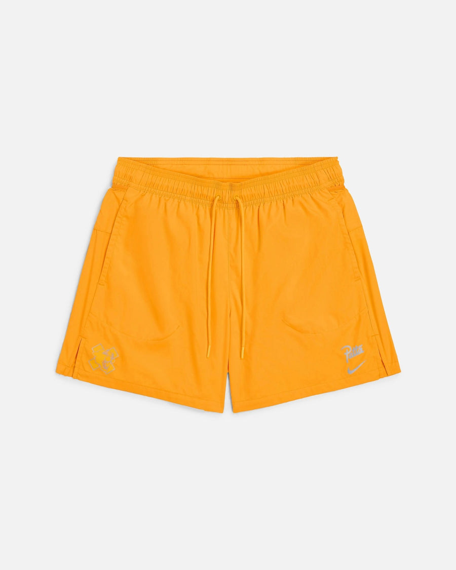 Front view of Nike x Patta Running Team nylon shorts in sundial orange with drawstring waist.