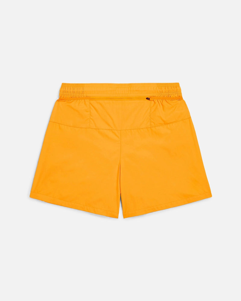 Back view of Nike x Patta Running Team shorts in Sundial orange with back zip pocket.
