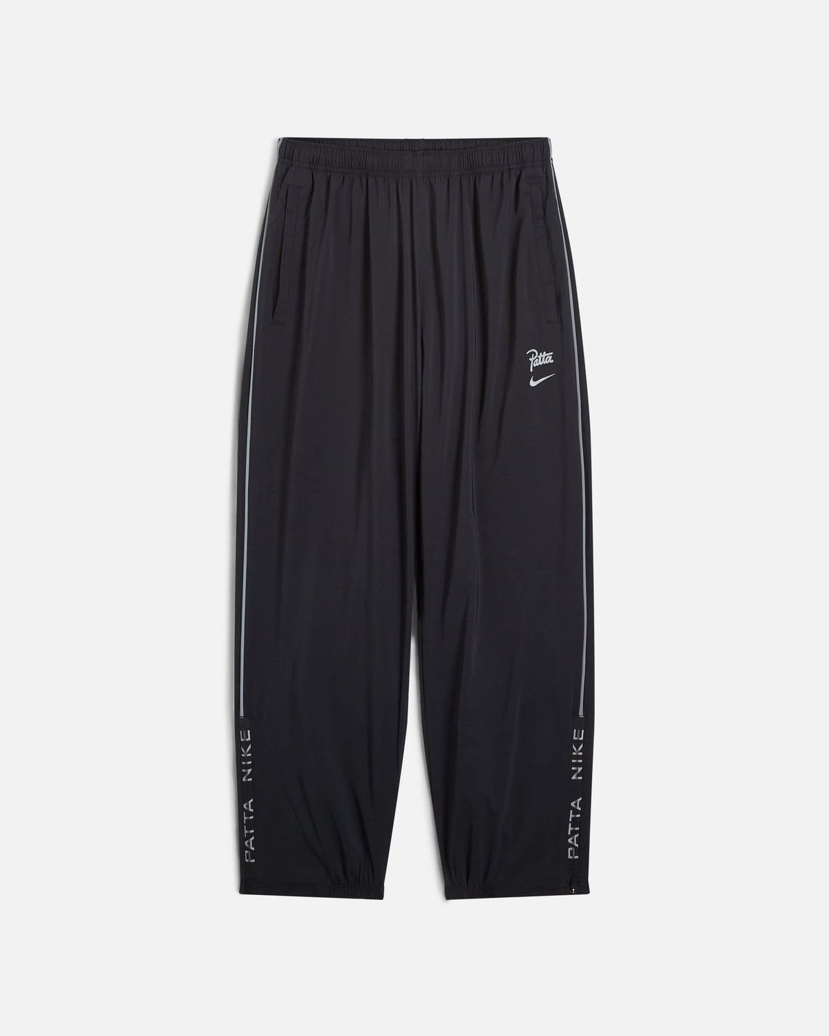 Front view of black Nike x Patta Running Team track pants with reflective side piping.