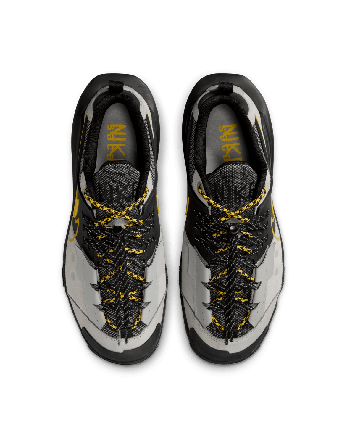 Top-down view of Nike x Sacai Zegamadome sneakers in matte silver, black, and tour yellow.