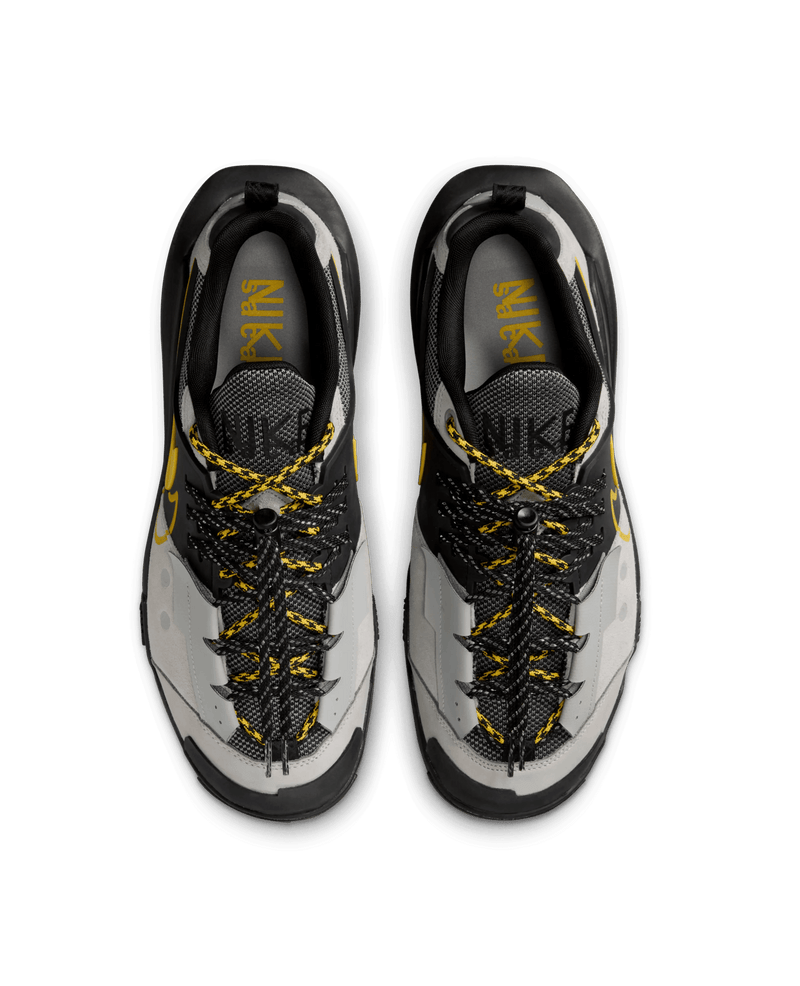 Top-down view of Nike x Sacai Zegamadome sneakers in matte silver, black, and tour yellow.