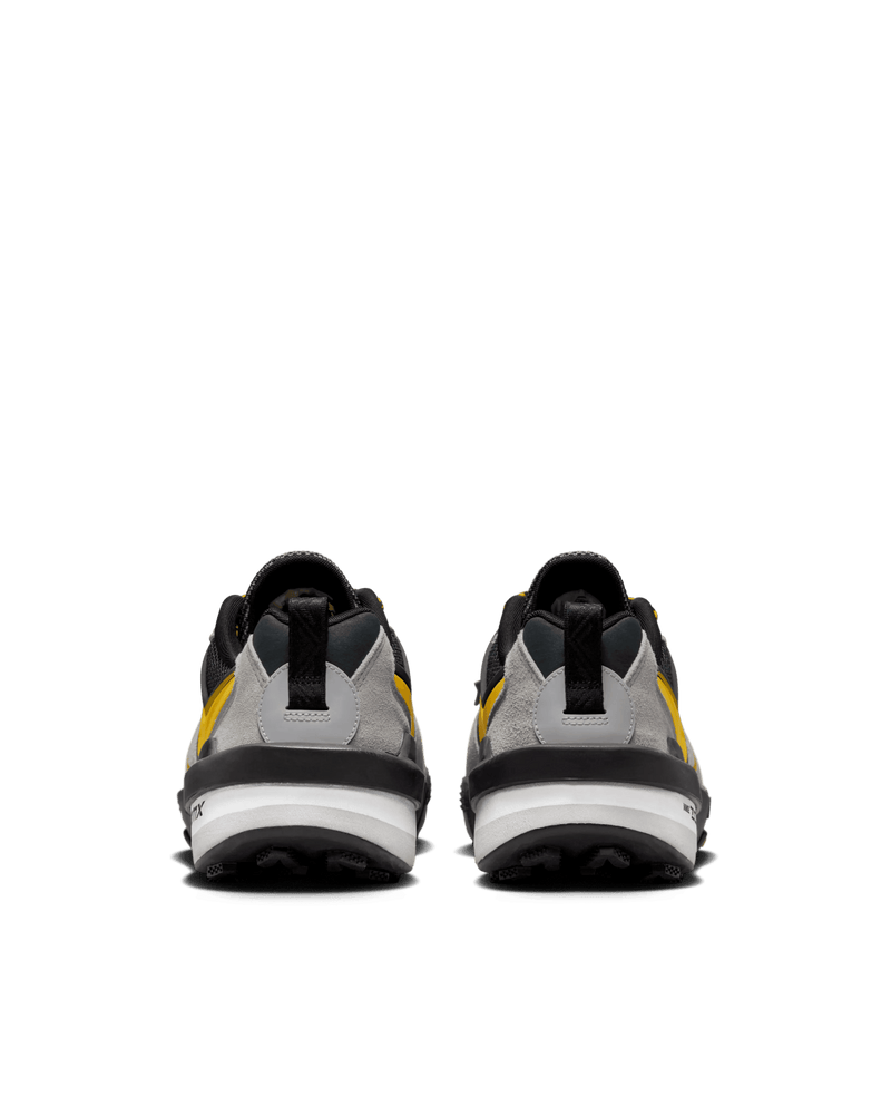 Rear view of Nike Zegamadome x Sacai sneakers in matte silver and tour yellow with layered heels.