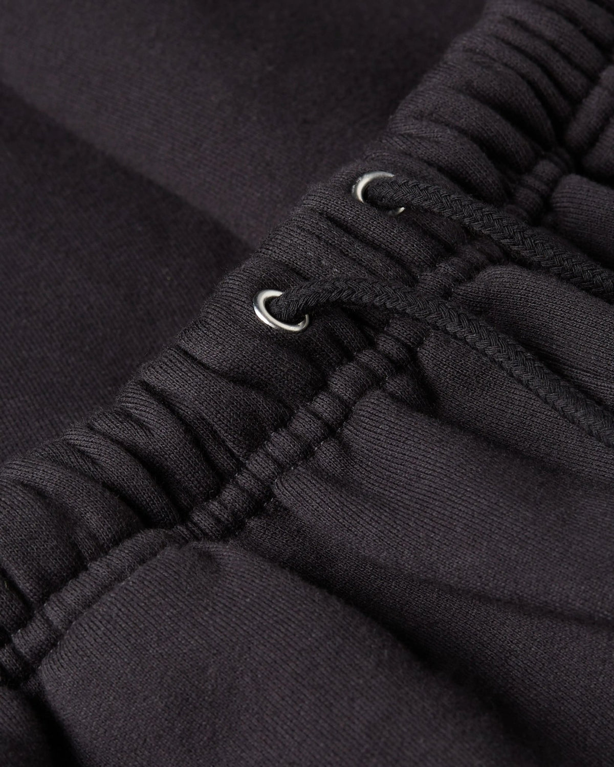 Close-up of the elastic drawstring waistband on the Patta Classic Jogging Shorts in black.